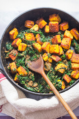 Saag paneer. Fried paneer cheese with turmeric, onion, garlic and spinach 