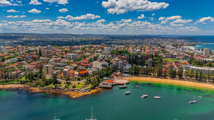 Aerial View of Manly Beach and Sydney harbour with manly houses on a warm summer day blue skies Sydney NSW Australia