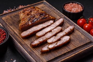 Juicy pork steak baked on the grill with salt, spices and herbs