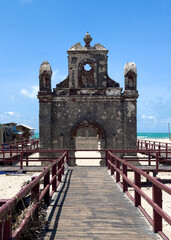 The Dhanushkodi Church, nestled in the ghost town of Dhanushkodi, Tamil Nadu, stands as a hauntingly beautiful relic of the past. Selective focus on foreground