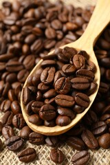Fototapeta premium Spoon with coffee beans on burlap