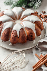 Christmas gingerbread cake glazed on white table with fir branches. Christmas festive dessert, homemade holiday baking recipe