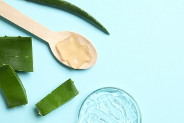 Cut aloe vera and cosmetic gel smears on color background