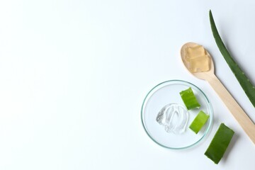 Cut aloe vera and cosmetic gel smears on color background