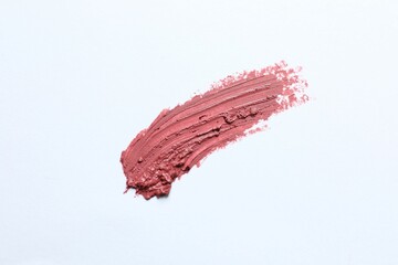 Smear of beautiful lipstick on white background, top view