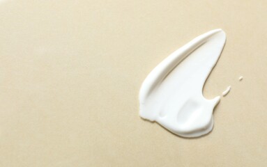 Smear of cream on a colored background