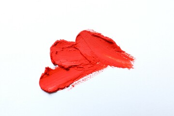 Smears of beautiful lipstick on white background, top view
