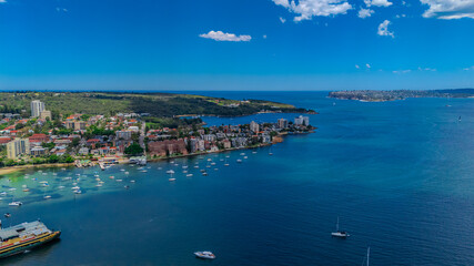 Fototapeta premium Aerial View of Manly Beach and Sydney harbour with manly houses on a warm summer day blue skies Sydney NSW Australia