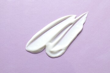 Smears of cream on a colored background