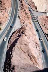 Aerial view of desert roads near Hoover Dam, showcasing rugged terrain and curved paths.