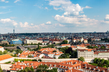 A vibrant view of Prague’s architecture, bridges, and skyline from Prague Castle on a sunny day.
