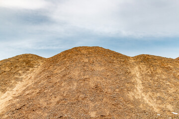 Natural-Looking Rolling Sand Dunes Formed in a Quarry Setting