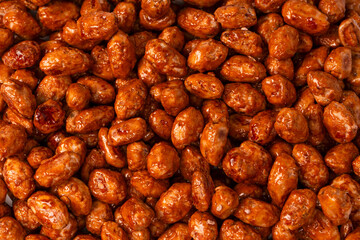 Tasty sweet roasted peanuts as a background.