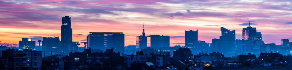 Large panoramic view during a colorful pink sunrise over the business district of Brussels Region, Belgium