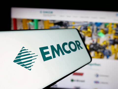 Stuttgart, Germany - 11-07-2024: Cellphone with logo of American engineering company EMCOR Group Inc. on screen in front of business website. Focus on left of phone display.