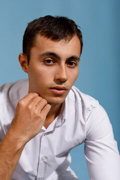 A young man dressed in a white shirt 