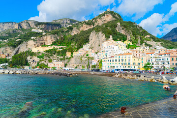 Amalfi old town and summer beach with umbrellas , Italy