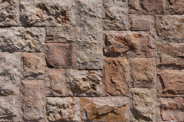 Wall with rectangular large textured facing natural stone