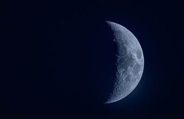 Half-moon glowing in the deep blue sky, creating a serene and celestial atmosphere.