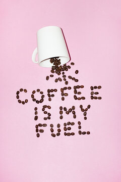 Coffee cup and coffee beans with playful text "coffee is my fuel" 