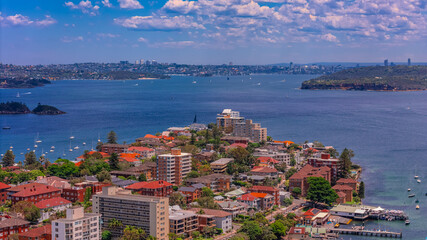 Aerial View of Manly Beach and Sydney harbour with manly houses on a warm summer day blue skies Sydney NSW Australia