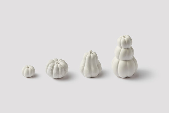 Dyed pumpkins placed in row from lowest to highest at studio