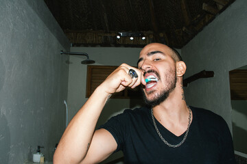Man brushing his teeth in the bathroom 
