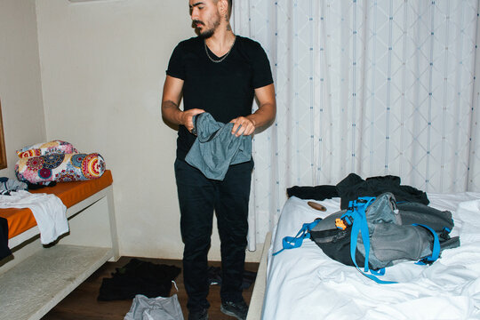 Man folding clothes neatly for trip