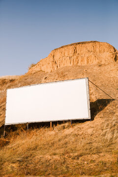 An empty billboard on a hillside