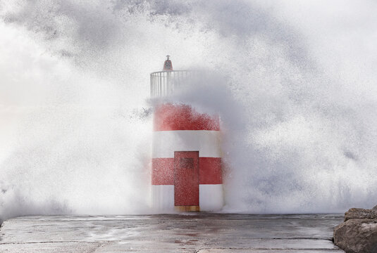 Wave crashing over lighthouse