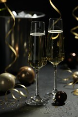 Champagne in glasses and decor on grey table. Christmas celebration
