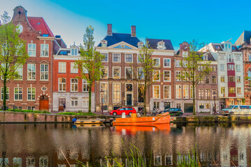 Fototapeta premium Facades of old historic Houses over canal water, Amsterdam, Netherlands