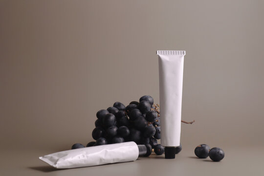 A minimalistic composition of a simple white cosmetic tube