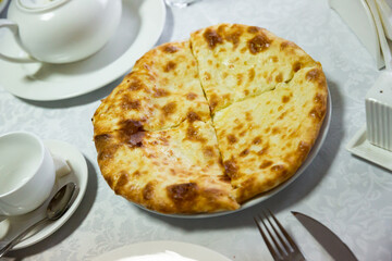 Traditional georgian food khachapuri with brynza cheese on a table