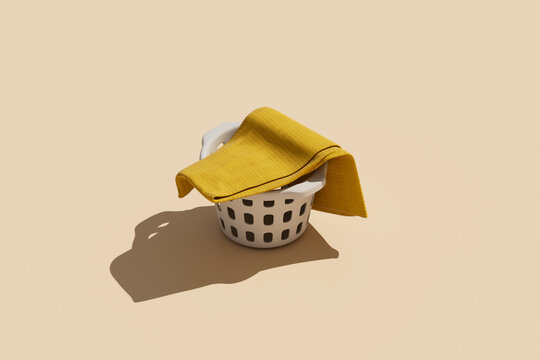 Single yellow towel draped over a laundry basket