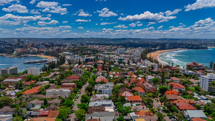Aerial View of Manly Beach and Sydney harbour with manly houses on a warm summer day blue skies Sydney NSW Australia