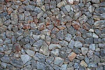 a stone wall, a stone wall built by hand by stacking stones on top of each other