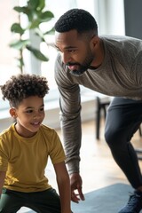 A joyful Black father and son engage in a playful fitness activity indoors, showing a bond of love and fun.