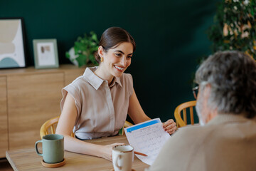 Financial advisor showing investment plan to senior man
