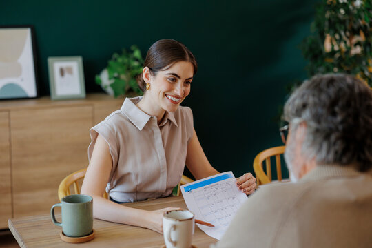 Financial advisor showing investment plan to senior man