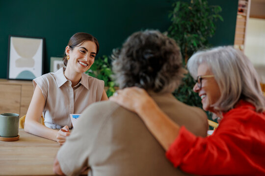 Financial advisor showing investment strategy to happy senior couple