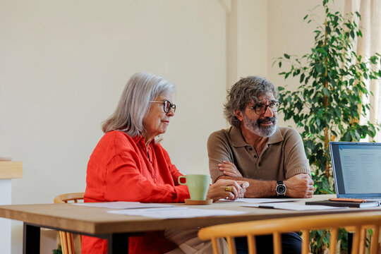 Couple planning finances on laptop at home