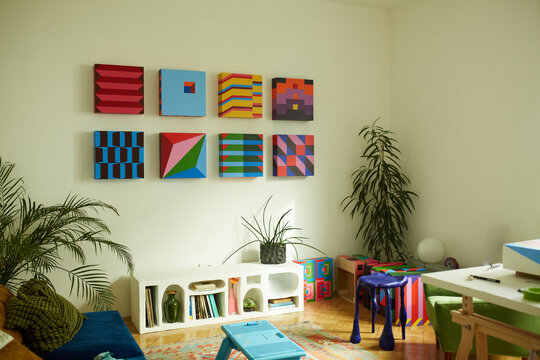 Colorful artworks hang on the living room wall