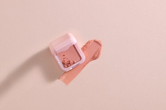 A pastel pink blush with a subtle swipe on a minimalist background