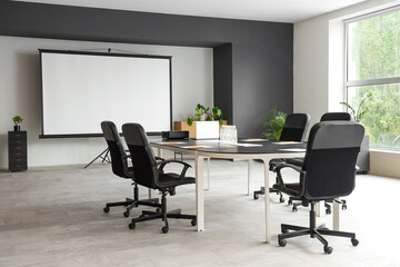 Interior of conference hall with table and projector screen