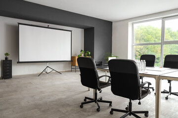 Interior of conference hall with table and projector screen