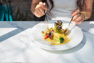 Woman Enjoying Gourmet Pasta with Caviar Outdoors