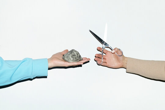 People playing rock paper scissors game with real objects with flash