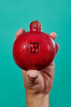 man with a pomegranate in his hand