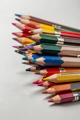 Fototapeta premium Colored pencils on white background. Close-up. Flatlay. Copy space 